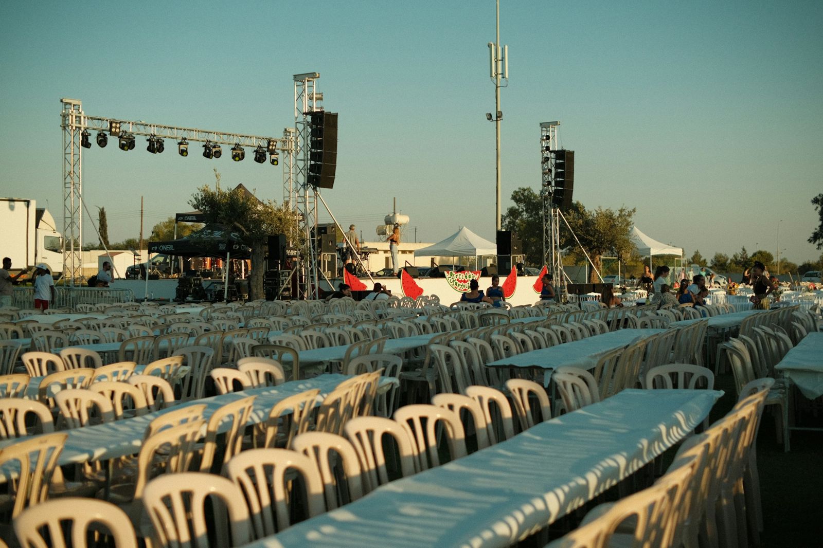 Rows of tables and chairs set up for an outdoor event